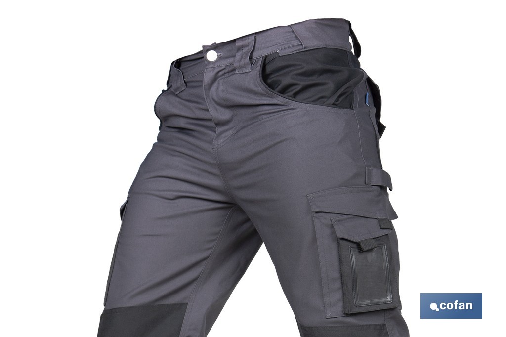 Pantalón de trabajo modelo Heimdall en gris oscuro y negro | Elástico, reforzado con múltiples bolsillos | Materiales: 65 % poliéster, 32 % algodón | Disponible en amplio rango de tallas - Cofan