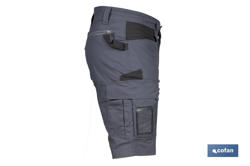 Bermudas de trabajo modelo Frigg en gris y negro | Elásticas, ligeras con múltiples bolsillos y protección lumbar| Materiales: 65 % poliéster y 32 % algodón | Disponibles en amplio rango de tallas - Cofan